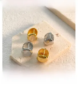 Detail view of water drop earrings with double-sided cat eye stone and honeycomb texture