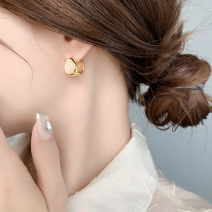 Elegant silver double-sided cat eye stone drop earrings worn by a model in a side view profile