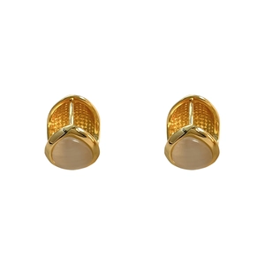 Double-sided cat eye stone teardrop earrings in gold finish with textured metal details