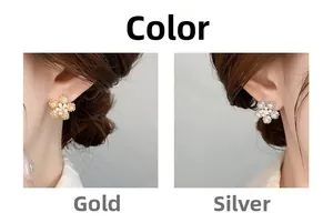 Detail of 18K gold plated snowflake earrings with zircons and pearls on model