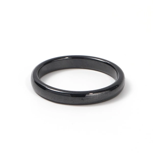 Polished black ceramic ring with diamond cut facets and minimalist glossy mirror finish