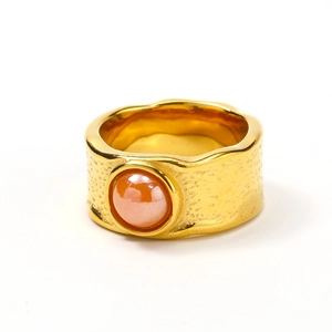Irregular gold foil texture wide band ring featuring a round translucent pink stone inlay
