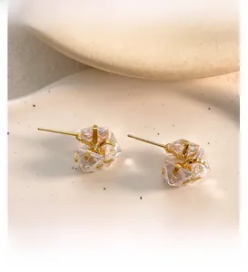 Detailed close-up of 18K gold plated stud earrings with clear square cubic zirconia stones