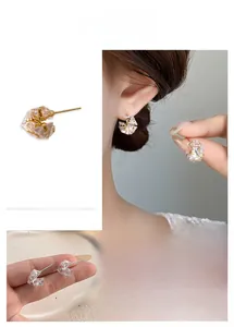 Detailed views of gold plated geometric sugar cube zircon stud earrings with faceted crystals