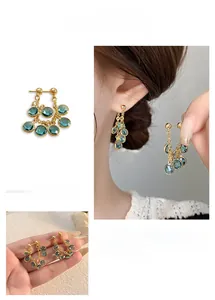 Detailed view of mint blue zircon tassel earrings with gold finish and layered design