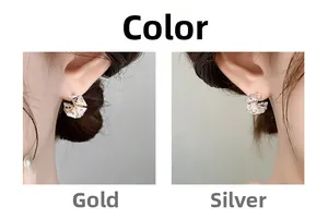 Detail view of square zircon earrings in gold and silver finish worn by a model