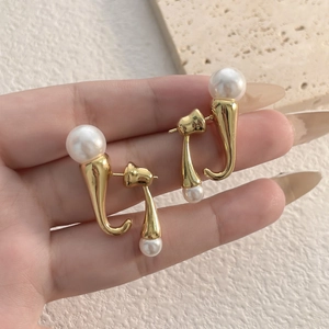 J-shaped gold pearl earrings featuring dual white pearls in a minimalist design