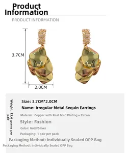 Detail view of gold seashell earrings with cubic zirconia and 3.7x2.0cm size dimensions