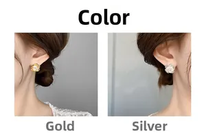 Detail of 18K gold and silver camellia flower earrings with sparkling cubic zirconia