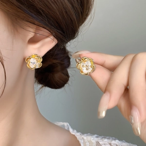 Elegant 18K gold plated flower stud earrings with zircon crystals shown on model