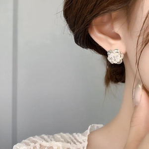 Elegant 18K gold plated flower stud earrings with zircon crystals on female model
