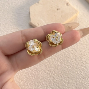 Detailed close-up of an elegant flower stud earring with 18K gold plating and zircon stones