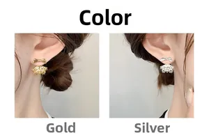 Detail of elegant bow earrings with hollow fan-shaped charms in gold and silver finish
