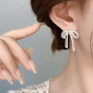 Elegant S925 silver lace bow earrings with sparkling cubic zirconia on model