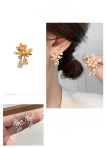 Detail of floral earring with pearls and marquise-cut zircons in gold and silver finish