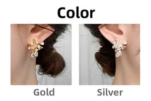 Close-up of elegant firework earrings with pearls and zircon on model ear