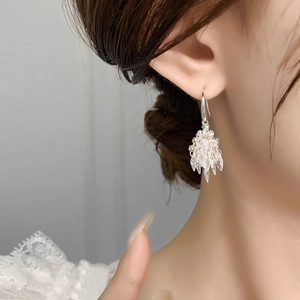 Elegant silver fireworks earrings with sparkling zircon crystals worn on model