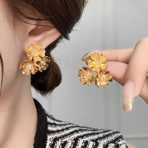 Elegant gold C-shaped flower stud earrings for women with detailed floral texture