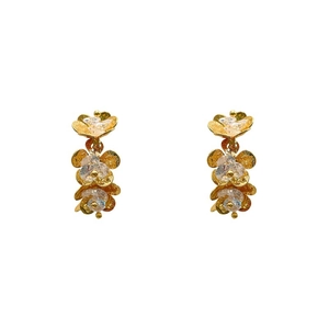 Elegant gold flower petal earrings with sparkling crystal center on a white background
