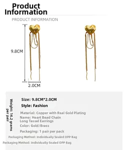 Detail view of gold-plated copper heart tassel earrings with dimensions 9.8cm by 2.0cm
