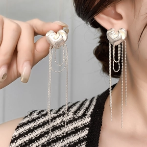 Silver plated heart stud earrings with long beaded tassel chains on model
