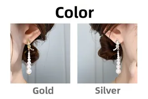 Boucles d'oreilles nœud et perle en finition or et argent portées