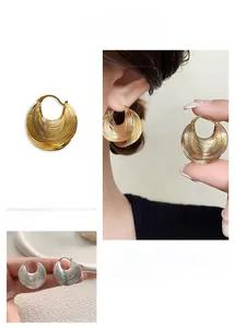 Detailed views of gold and silver chunky textured earrings with layered wave design
