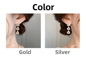 Detailed view of triple triangle zircon drop earrings in gold and silver finish