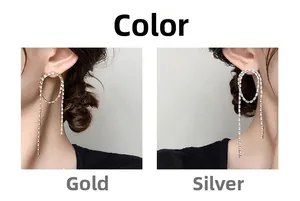 Close-up of gold and silver tassel earrings with sparkling rhinestones on model