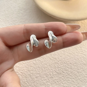Modern irregular twisted silver stud earrings with high-polish metallic finish for women