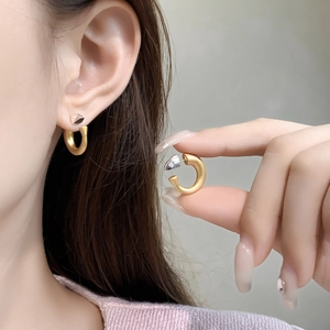 Minimalist 18K gold plated C-shaped matte hoop earrings shown on ear for women