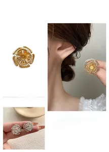 Gros plan de boucles d'oreilles tournesol en métal tissé plaqué or et argent
