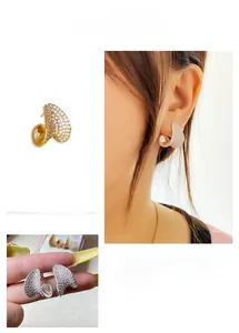 Macro detail and on-model view of sparkling curved heart earrings with pavé crystals
