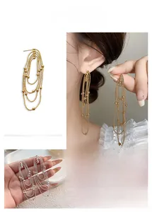 Detailed layered tassel drop earrings with sparkling geometric chain drapes in gold and silver