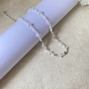 Detail of baroque pearl and zircon necklace with gold heart pendant and adjustable lobster clasp