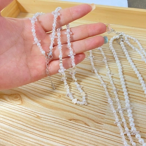 Detail of baroque pearl and zircon necklace with heart charms and lobster clasp