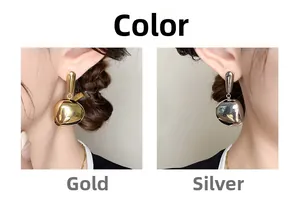 Detail view of irregular liquid metal pebble earrings in gold and silver finish