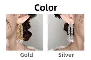 Detail view of gold and silver tassel earrings with delicate beaded chains and zircons