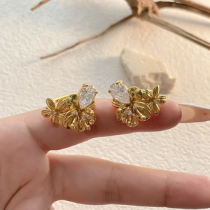 Élégante boucle d'oreille fleur en or avec zircon poire et pétales en métal brossé