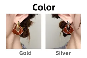 Detail of fan-shaped vintage enamel earrings shown in gold and silver finish