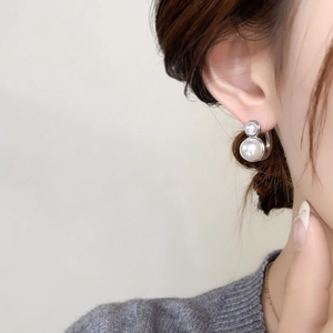 Macro detail of French vintage silver pearl earrings with layered double pearl drop design