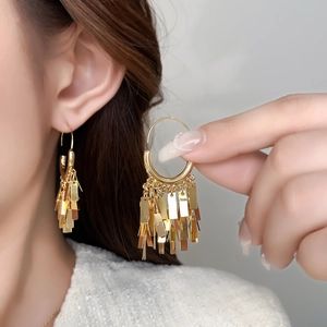 Elegant gold fringe drop earrings with sleek metallic tassels in a polished finish