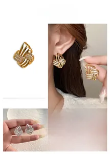 Detail showing gold and silver twisted knot earrings with micro-pave cubic zirconia stones