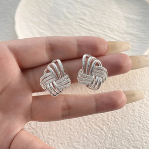 Silver woven knot stud earrings with cubic zirconia stones in a luxury geometric design