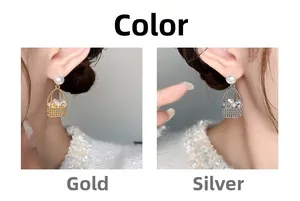 Detailed view of pearl earrings in gold and silver basket design on a model