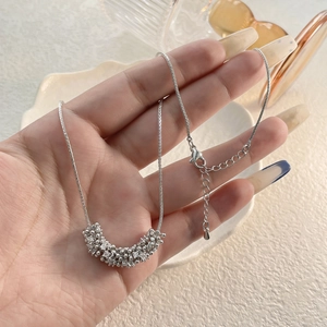 Macro detail of silver beaded cluster pendant necklace with adjustable chain length