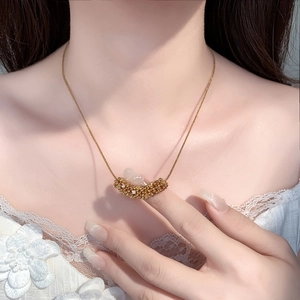 Elegant gold crescent pendant necklace with shimmering zircon stones on a female model