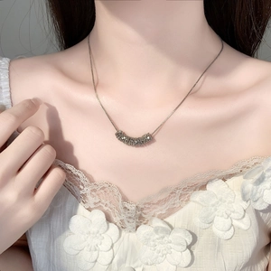 Elegant silver zircon clavicle necklace with curved pavé crystal pendant on a woman