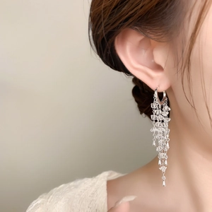 Detail of silver long tassel earrings with waterfall beads and 18K gold plated hoop