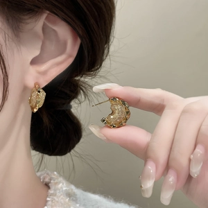 Chic irregular geometric C-shape earrings with textured gold finish and crystal details